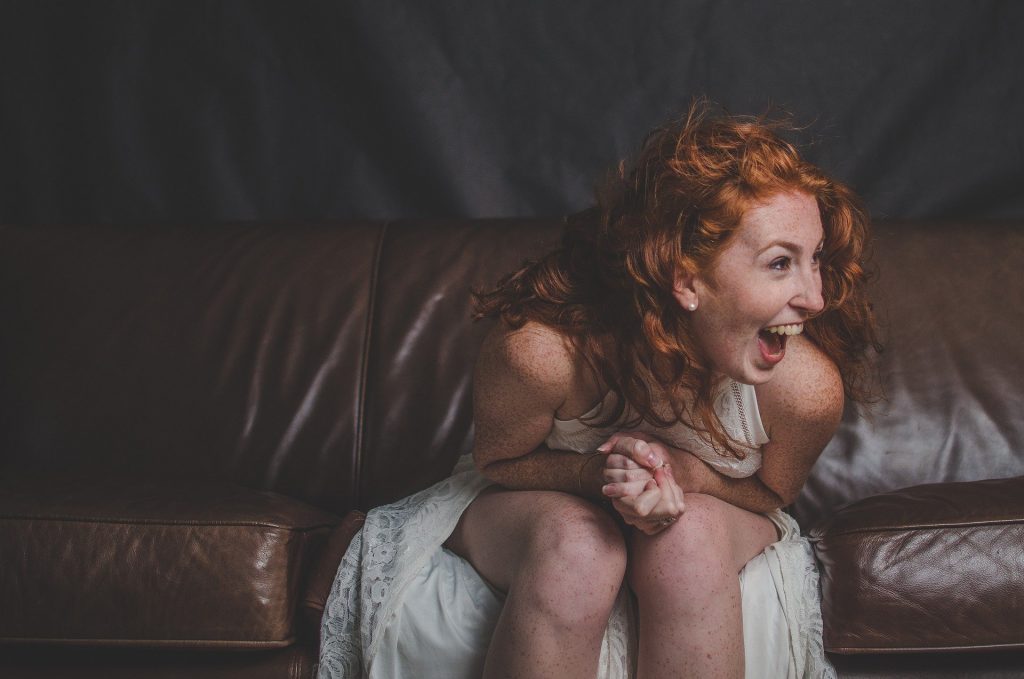 Overjoyed woman sitting on a couch